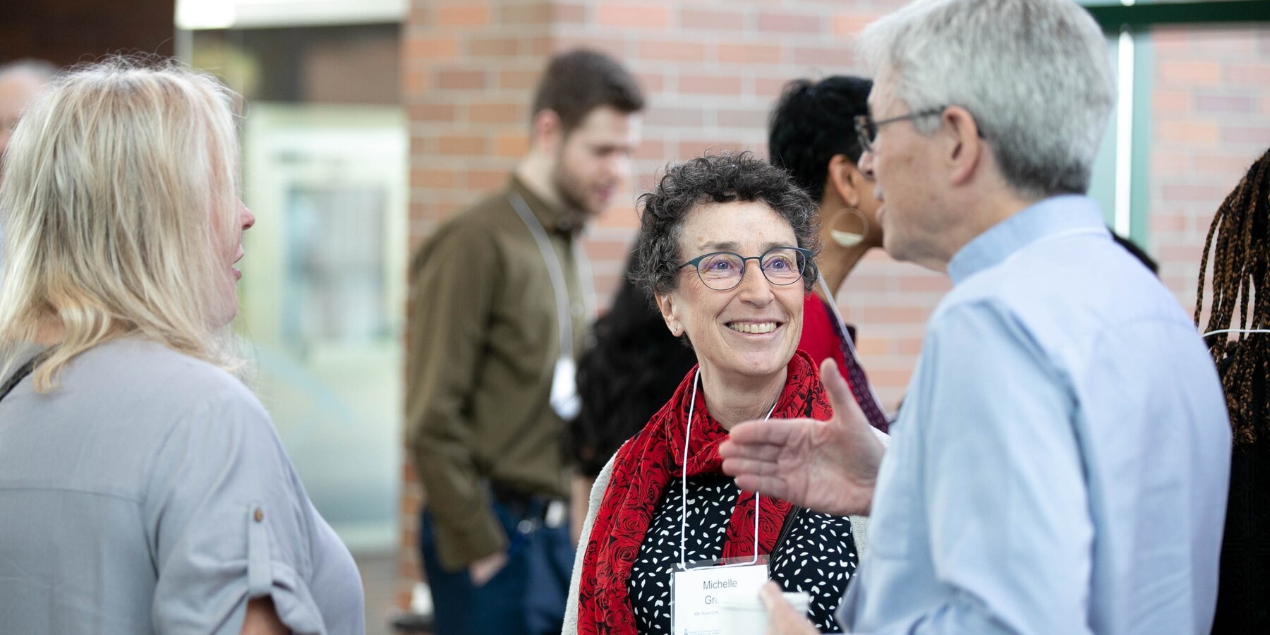 Three colleagues gathered around in a discussion