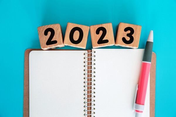 Blank notebook with 2023 on wooden blocks above