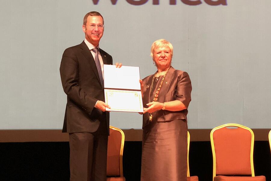 WONCA president Amanda Howe presenting DFCM Chair Dr. Michael Kidd with DFCM's WONCA accreditation certificate to DFCM