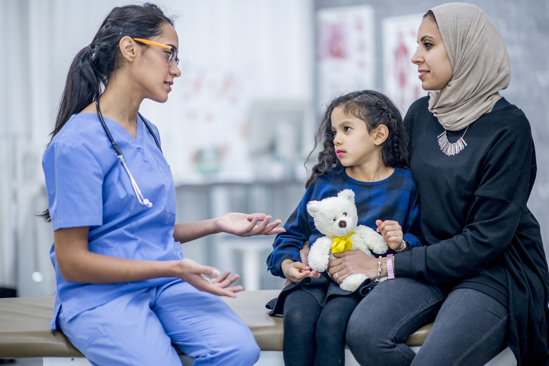 Doctor talking with mother and child 
