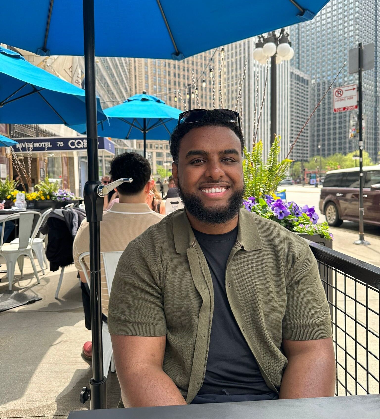 Dr. Bilal Negash on a patio, smiling