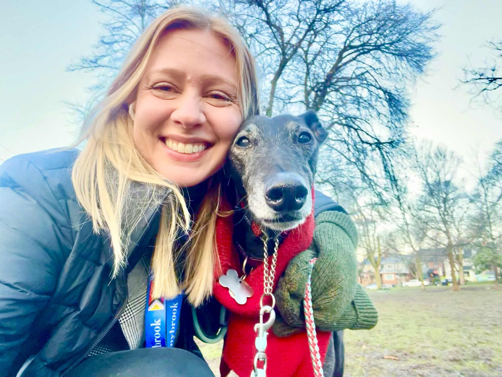 Dr. Robyn Moxley and her greyhound in a park
