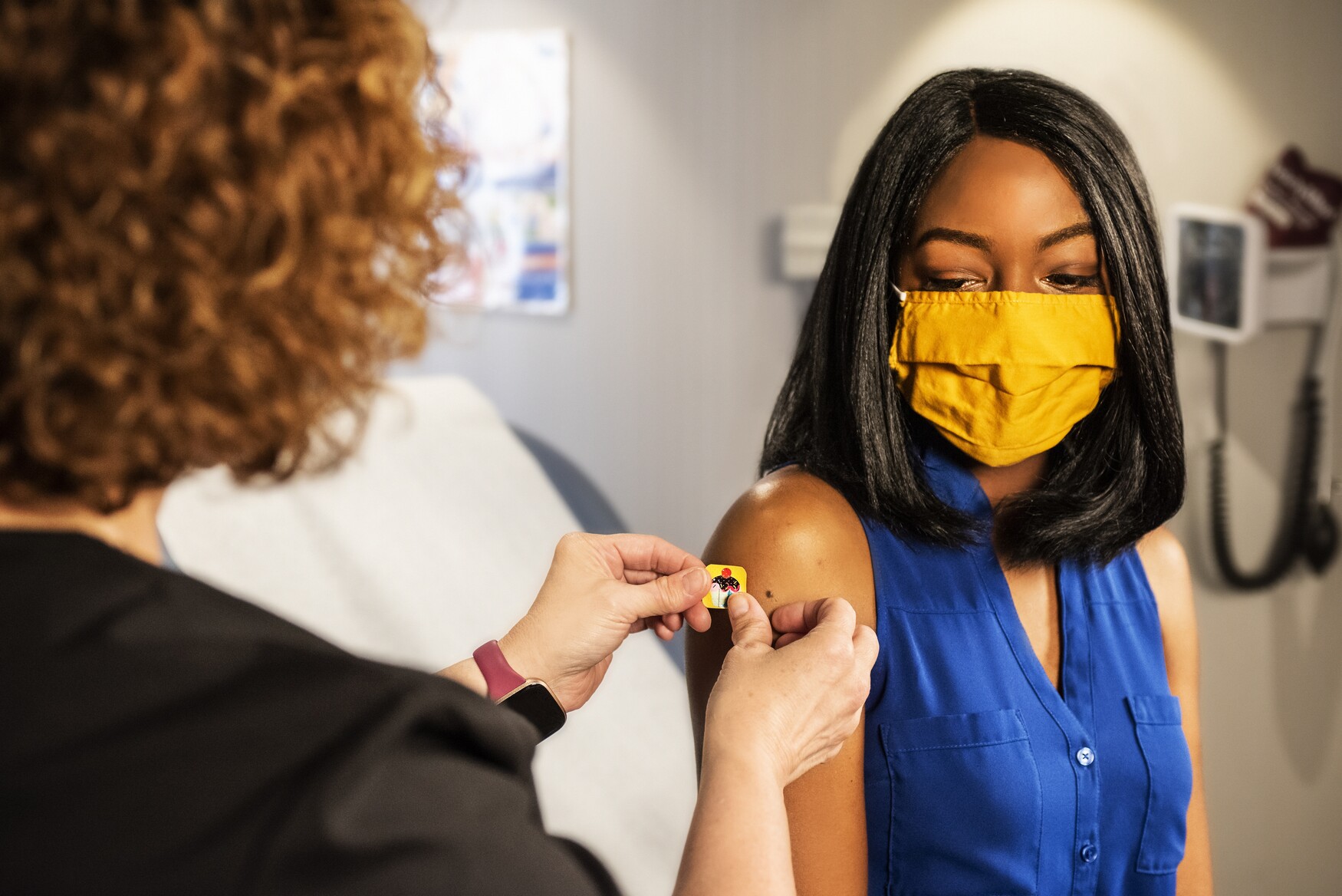 Woman wearing mask gets a vaccine
