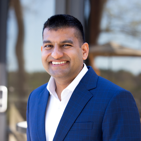 photo of man in a blue suit smiling
