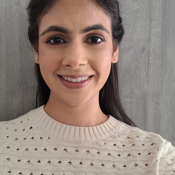 photo of woman smiling with a white sweater on