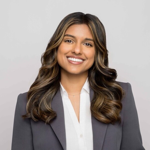 photo of woman smiling with long hair and gray blazer