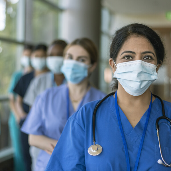 Doctors lined up wearing masks