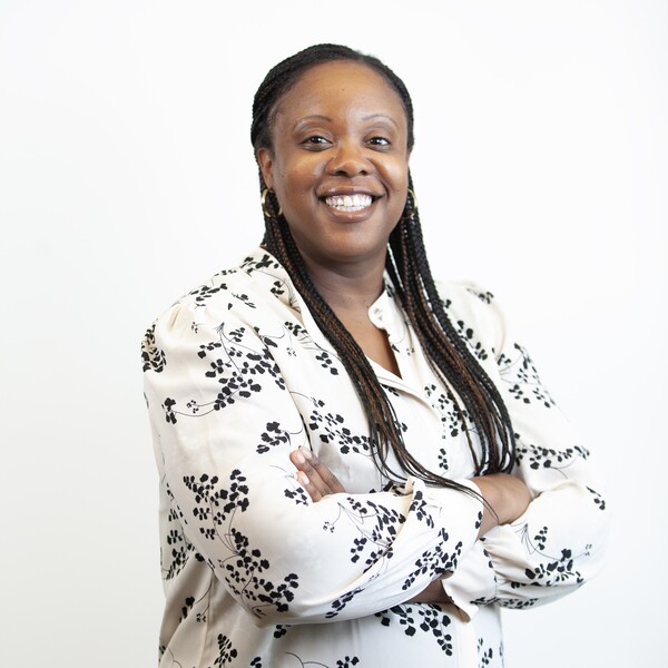 woman smiling with arms folded