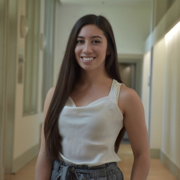 woman with long hair smiling at camera